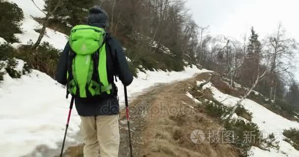 在多雪的线索路径上行走的背包徒步旅行者的男人。跟在后面。真正的背包客人成年后徒步旅行或在秋天或冬天在野生山户外徒步性质，坏雾 w