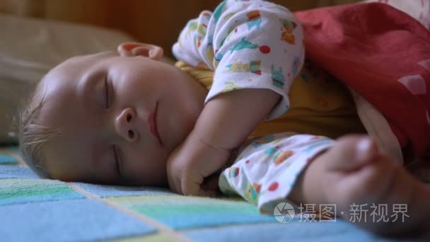 睡眠和醒来在床上的婴儿的肖像视频