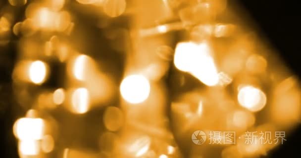 抽象的圆形金色闪光闪光散景流动运动在黑色的背景，祝贺问候方快乐新的一年，圣诞节的庆祝活动上