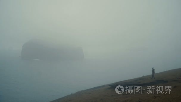 在雾天站在海边的年轻女子  享受在冰岛的看法  思考的东西