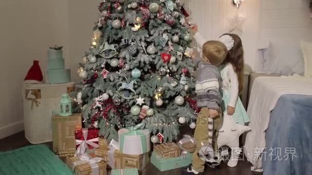 两个小孩子装饰圣诞树视频