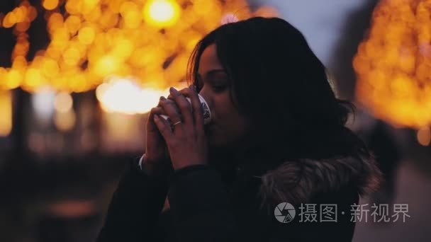 美丽的多种族妇女在夜城市喝茶视频