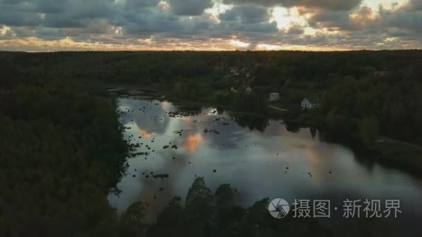 日落时在湖面上飞行的无人驾驶飞机