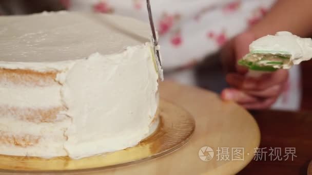 女孩是涂抹蛋糕两侧的奶油视频
