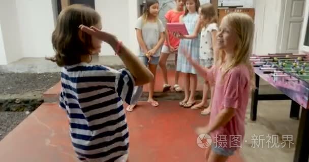 两个年轻的女孩高五和加入他们的不同族群的混合种族朋友视频