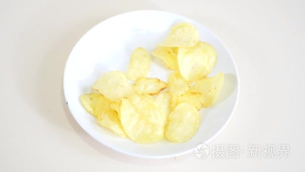 孩子男孩拿着他的手薯片从一个白色的盘子, 特写