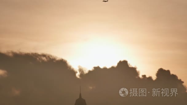 在日出或日落的背景下  从远处起飞飞机。飞机的剪影。飞机在天空日落