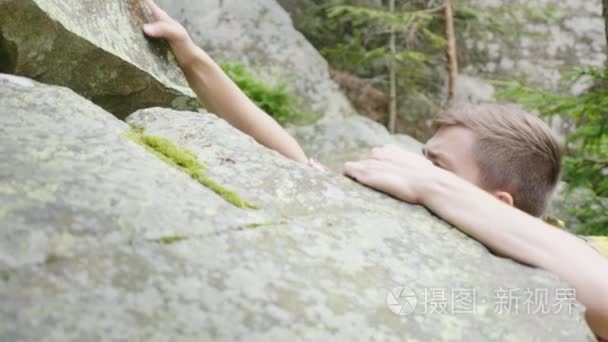 有目的的年轻人爬上岩石