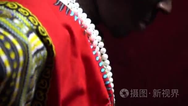 侧面视图作为一个黑人男子在 dashiki 把他的肩膀上的手帕