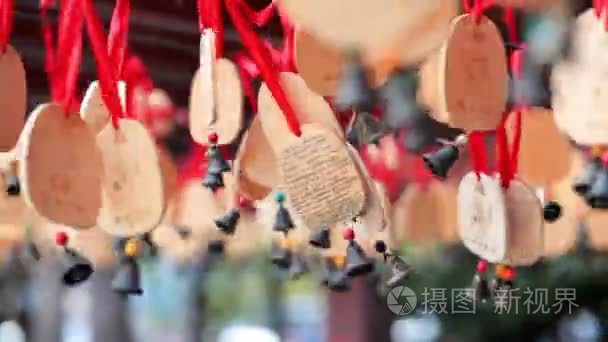 木制的钟声与愿望挂起  从风中移动。海南  中国。Clouse 了红丝带上的铃铛