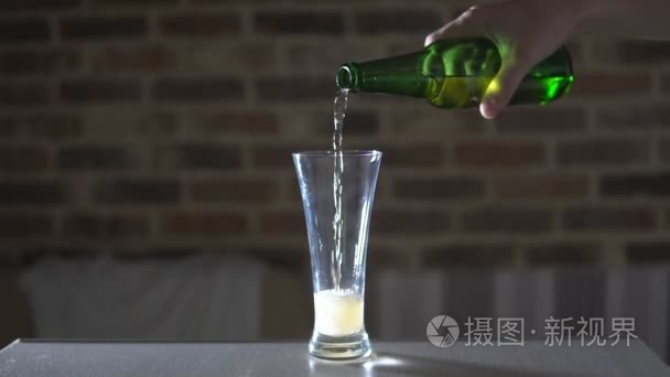 啤酒从瓶子里流进玻璃烧杯中