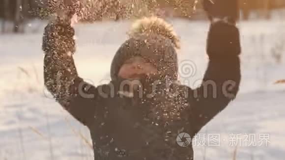 一个小男孩正在向空中扔雪视频