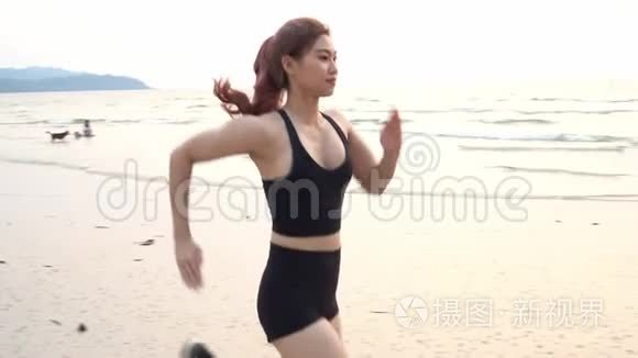 强壮的女人在沙滩上跑步和锻炼