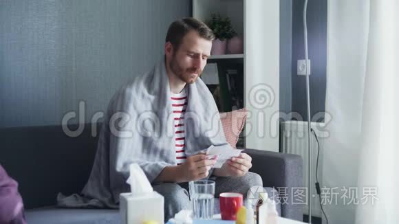 一个成年病人坐在沙发上，用水吃药