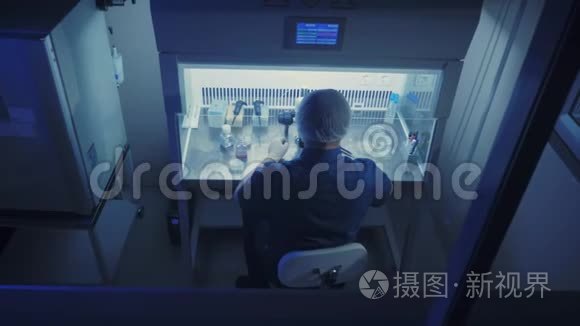 在一个现代的实验室科学家进行实验。 胚胎学家用显微镜检查样本