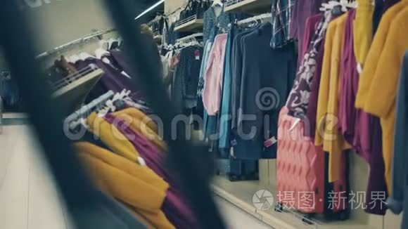 两个微笑的女人正沿着服装店走着