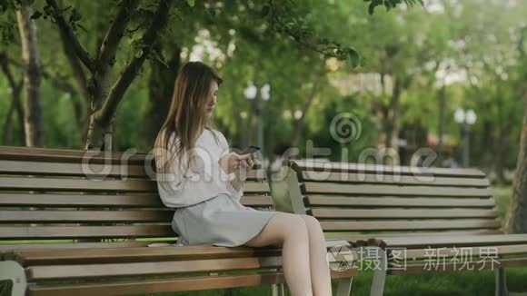 坐在公园里坐轮椅的年轻人和坐在长凳上悲伤地看着他