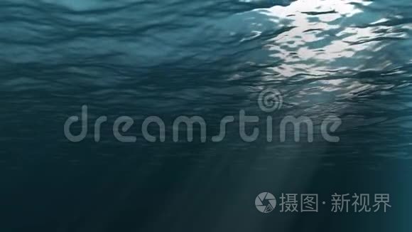 水下背景。从上面射出的光线穿过波浪和深蓝色的海水。