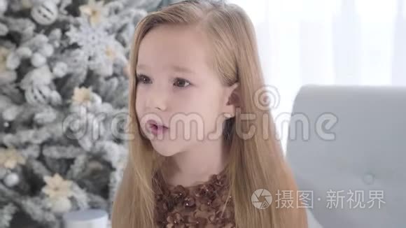 镜头围绕着一个长着长发的可爱白人女孩的脸移动。 坐在新街圣诞树旁的漂亮孩子