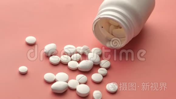 白色药丸溅在粉红色背景上，关闭