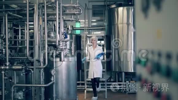 工厂生产线的质量控制。 一个人在乳品厂检查金属罐。