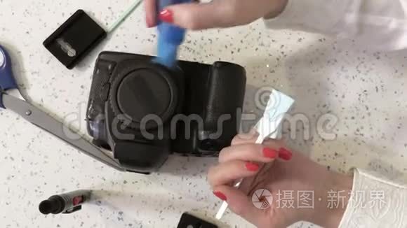 女摄影师清洗脏摄像头传感器.