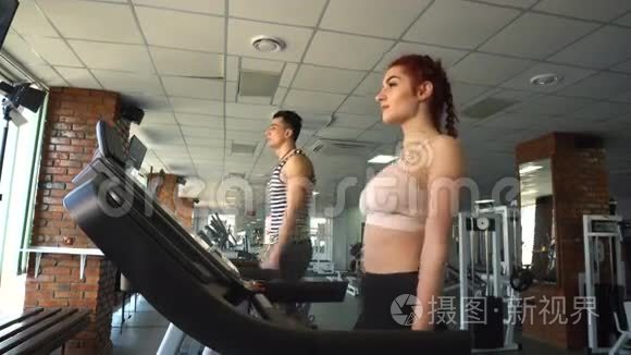 健身男女在跑步机上行走视频