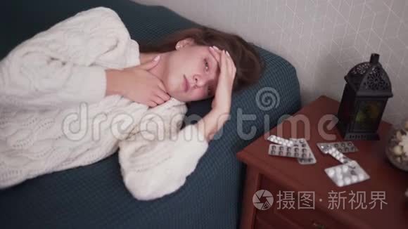 一个生病的女人看着相机，紧贴着她的头，头痛。 流感。 感染和温度