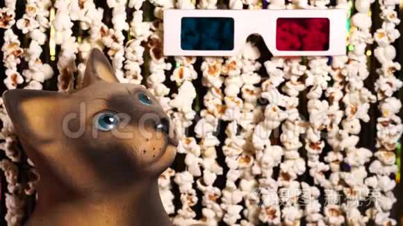 猫雕像看着3D眼镜。 爆米花和金色闪闪发光的金属圈的动态背景离焦