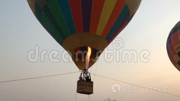 关闭彩色热气球中的丙烷气体燃烧机在地面上空飞行的视频