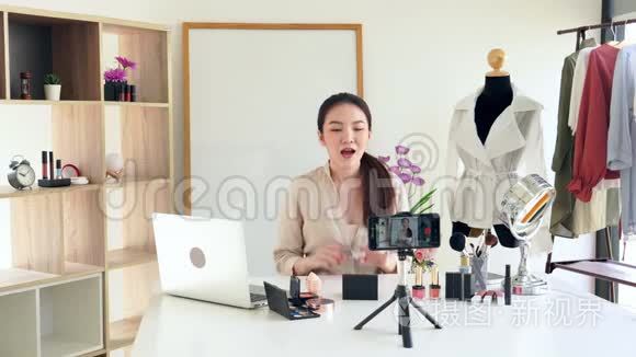著名博主的4K视频。 开朗的女性vlogger在录制日常化妆视频时展示化妆品