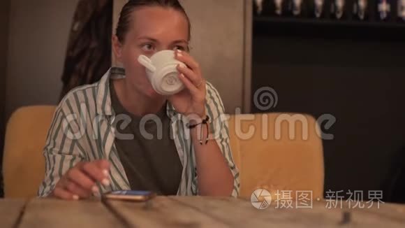 女人喝着咖啡看着手机