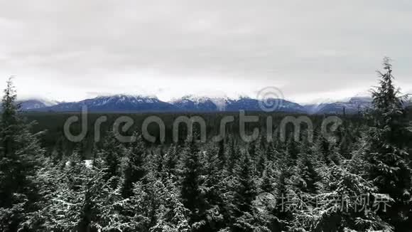 一架无人机照相机在寒冷的一天，沿着雪山的顶端滑行。