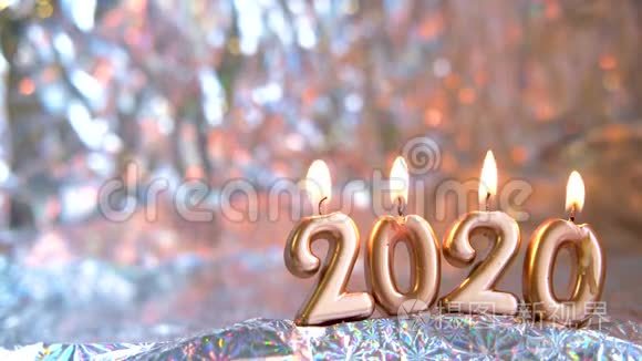 文字2020年金烛燃烧.. 模糊的银色背景。 宇宙空间。 圣诞快乐，新年快乐。 选择性