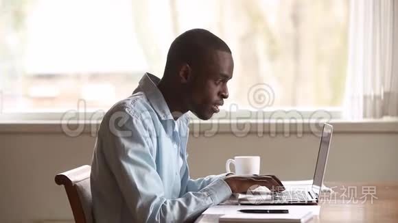 快乐的非洲年轻人用笔记本电脑在线阅读新闻