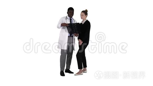 年轻女子在白色背景下接受X光检查的放射科医生。