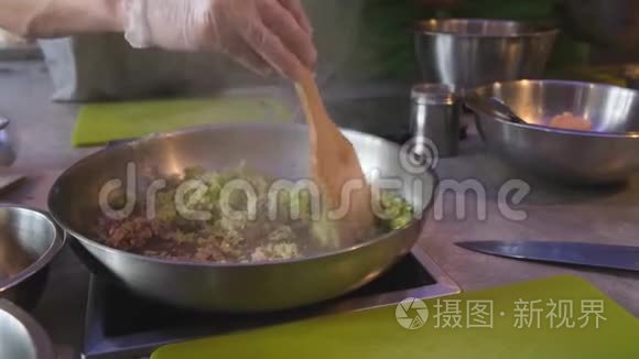 厨师用橄榄油搅拌洋葱和芹菜丁视频