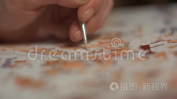 女人的手在画布上画一条细流苏视频