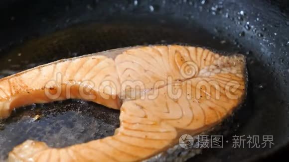 在热锅中进行特写镜头烹饪和烤三文鱼牛排，食物健康