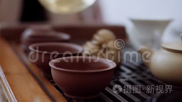 中国茶道，桌上是三杯，他们从一个水壶里倒出来。 特写