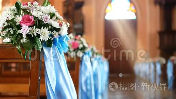4K. 空教堂的内部景观，木制长凳上装饰着花束和被风吹过的蓝色丝带