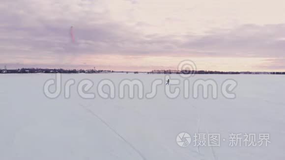 冬天在滑雪板或滑雪板上风筝。 在风中在冰上滑冰。 美丽的彩帆。