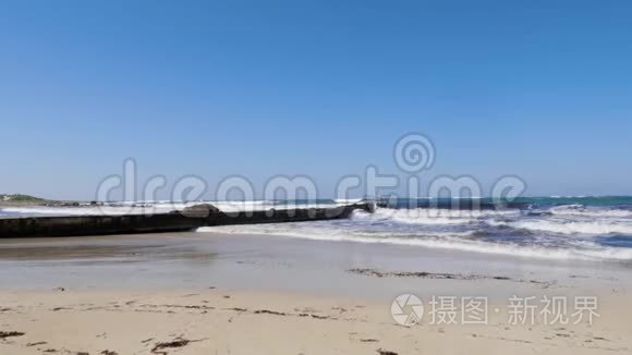 在阳光明媚的多风天气里，强烈的海浪拍打着码头和沙滩。 塞浦路斯海滩暴风雨天气。 慢动作