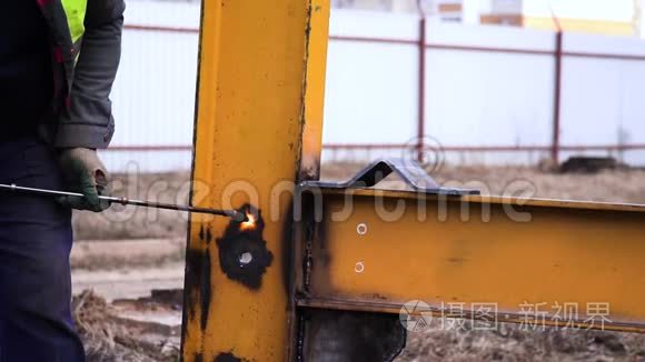 特种手套工业工人在黄色金属施工中用割炬切割金属。