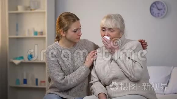 孙女拥抱和支持哭泣的祖母，不治之症