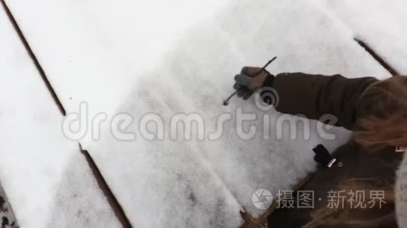 小女孩在雪地上画着心形视频