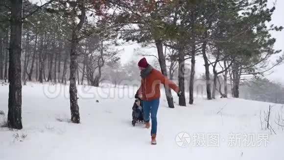 可爱的夫妇在下雪的冬天滑雪。 下雪时，男人和女朋友拉雪橇。 女人玩得开心