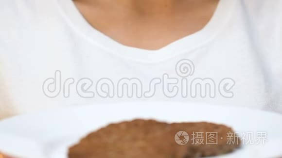 女人在镜头前表现出肥胖，不健康的饮食和垃圾食品成瘾