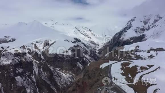 滑翔伞在白雪皑皑的群山中飞翔视频