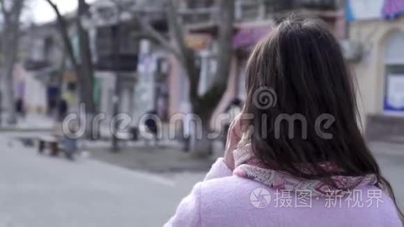 女性在室外近距离行走时通过电话进行交流